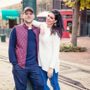 couple standing by light pole in downtown memphis - about Cat's Ballroom testimonial