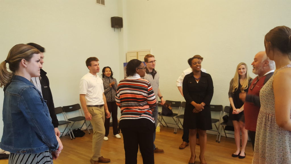 group of people listening to an instructor during a group class - dance lessons