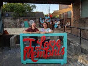Cat (owner of Cat's Ballroom) and Jesse standing behind and I Love Memphis sign.