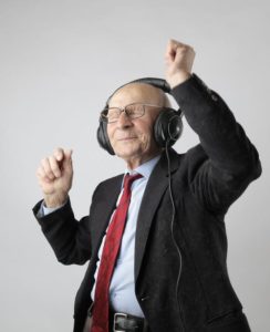 an older man with headphones dancing