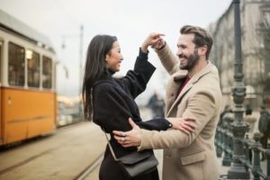 a couple practicing dancing by a trolley