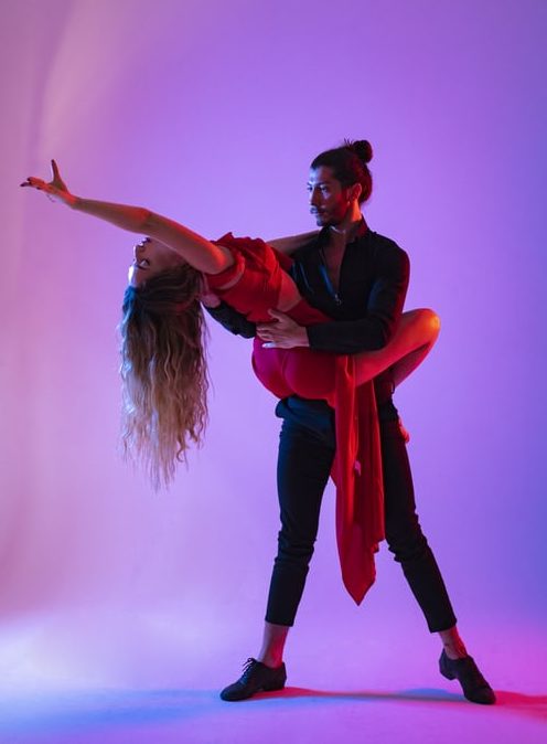 couple doing a lift to illustrate poor ballroom etiquette in a social situation