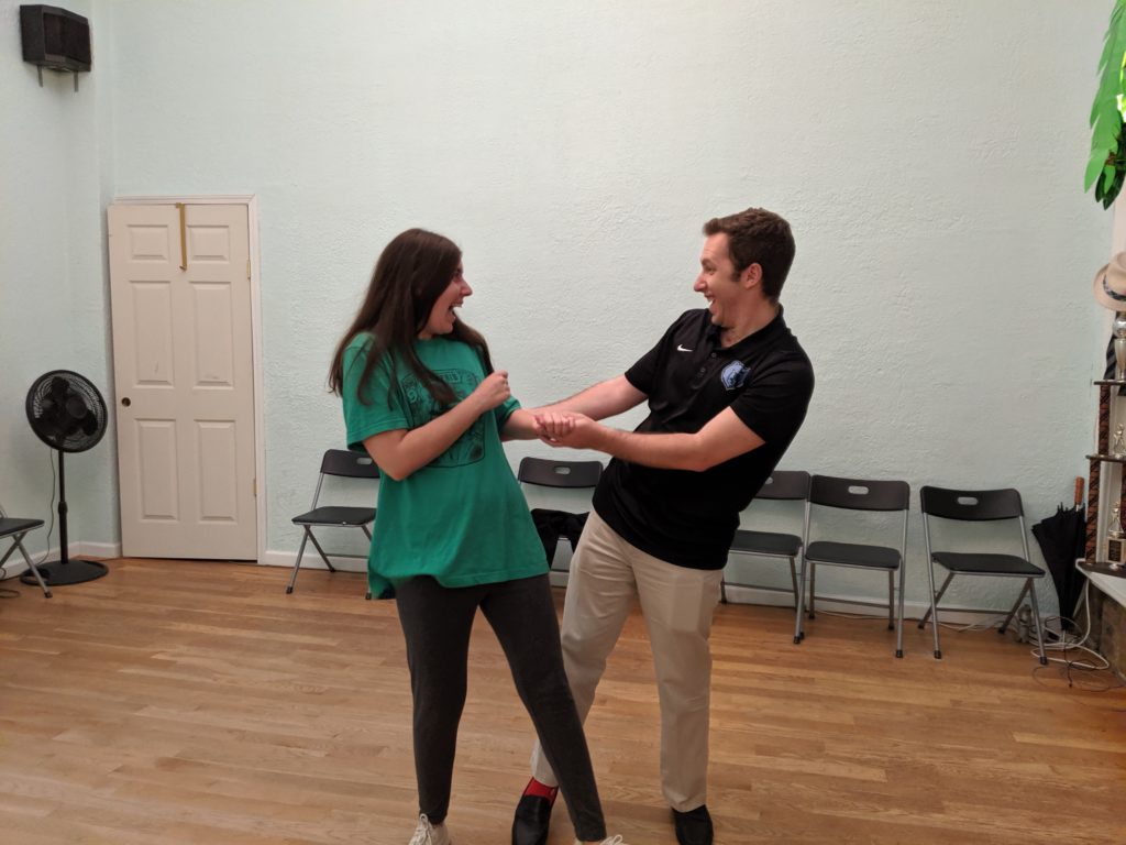 couple turning to look at each other playfully - a line in Hayley & Max's first dance