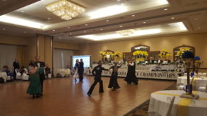 couples dancing in a competition following a ballroom dance syllabus