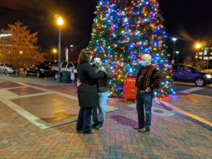Couple dancing in front of Christmas tree
