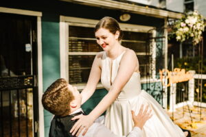 Man kneeling in front of woman during first dance