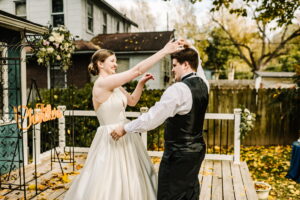 Woman looping hand over man's head during first dance