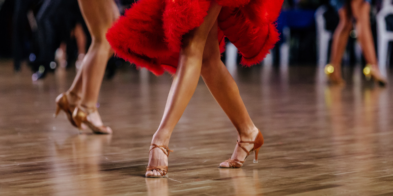 Shot showing the legs of dancers wearing ballroom dance shoes.