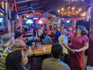 group from Cat's Ballroom dancing and watching karaoke