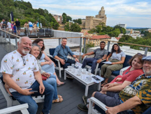 The crew from Cat's Ballroom relaxing at a rooftop bar during their dance weekend in Hot Springs