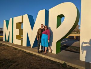 Couple posing in front of Memphis sign.