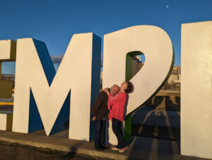 Couple posing in front of Memphis sign.