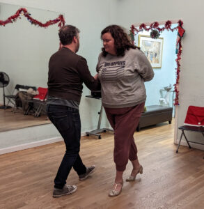 Couple practicing a hammerlock move