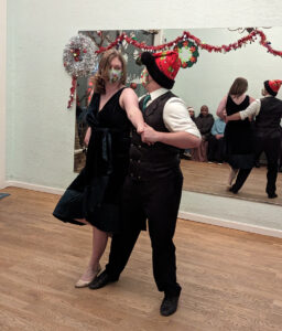 Couple executing an oblique line with kicks at the Cat's Ballroom 2022 Winter Show