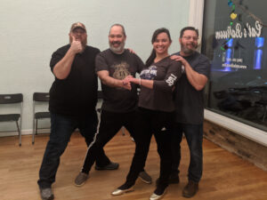 A bride-to-be posing with her father and 2 step-fathers.