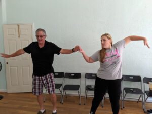 A father and daughter practicing the wave.