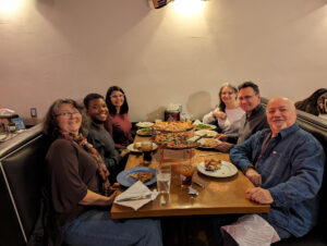 Participants in the big band getaway relaxing over pizza.