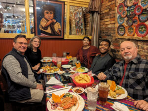 Last evening of dance getaway seated in a booth with Central American decor and food.